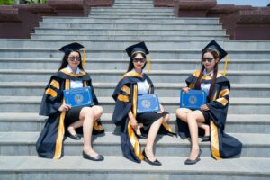 graduates celebrating at outdoor ceremony